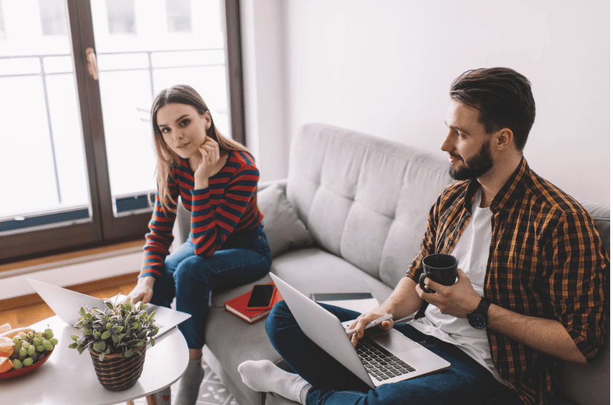 A relaxed conversation between a man and a woman in a cozy room, symbolizing calmness and support during anxiety recovery